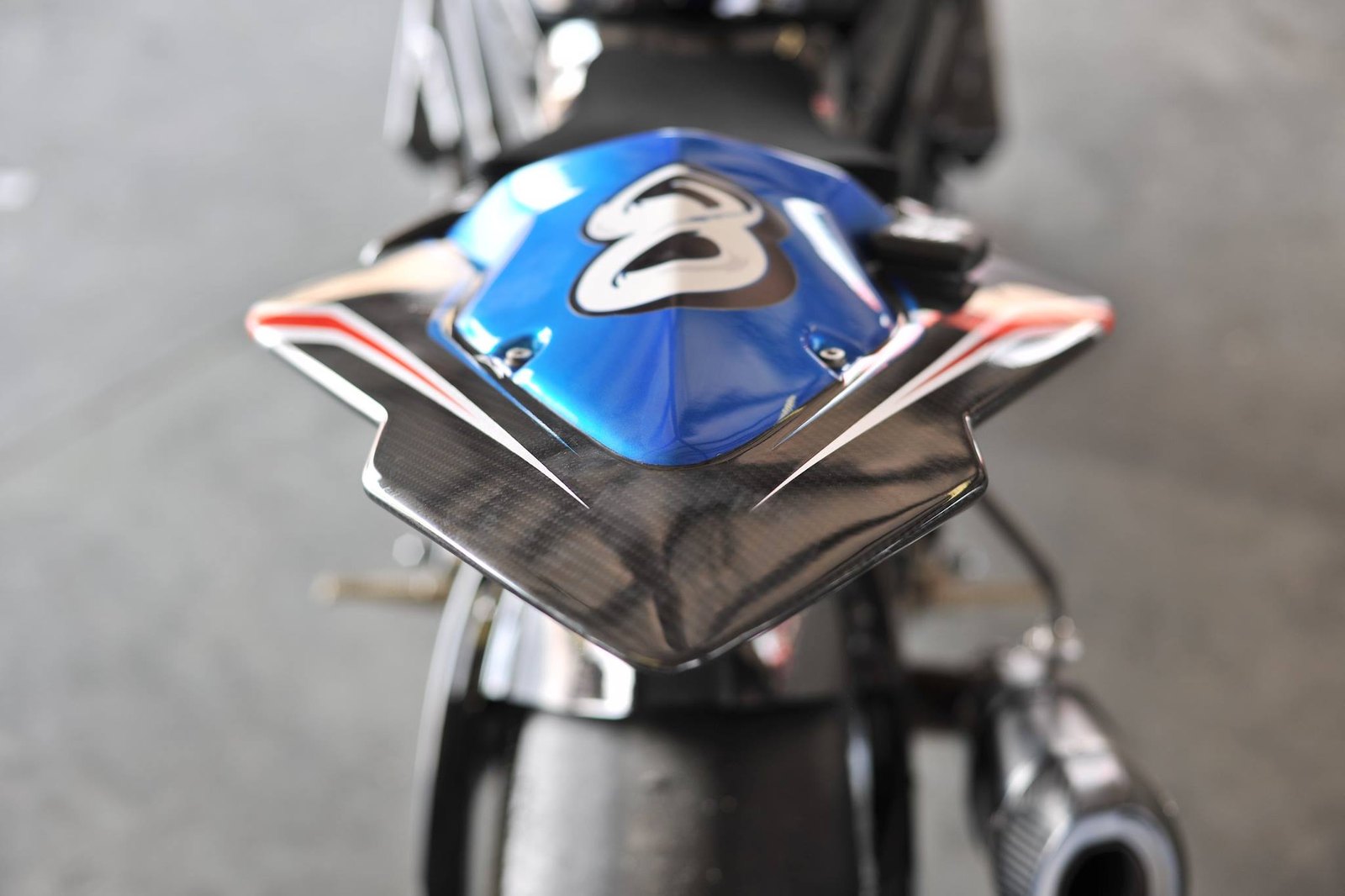 Rear view of a blue race bike with a carbon fiber tail section